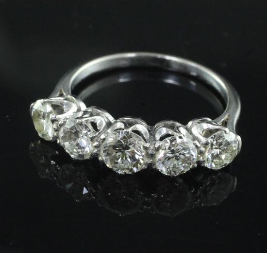 A mid 20th century platinum? and graduated five stone diamond ring, size M.